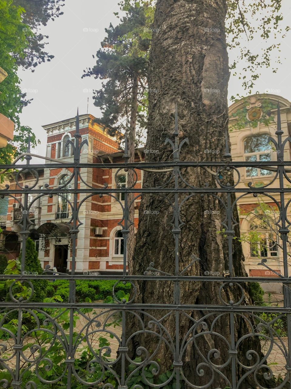 Old beautiful building behind a metal fence 