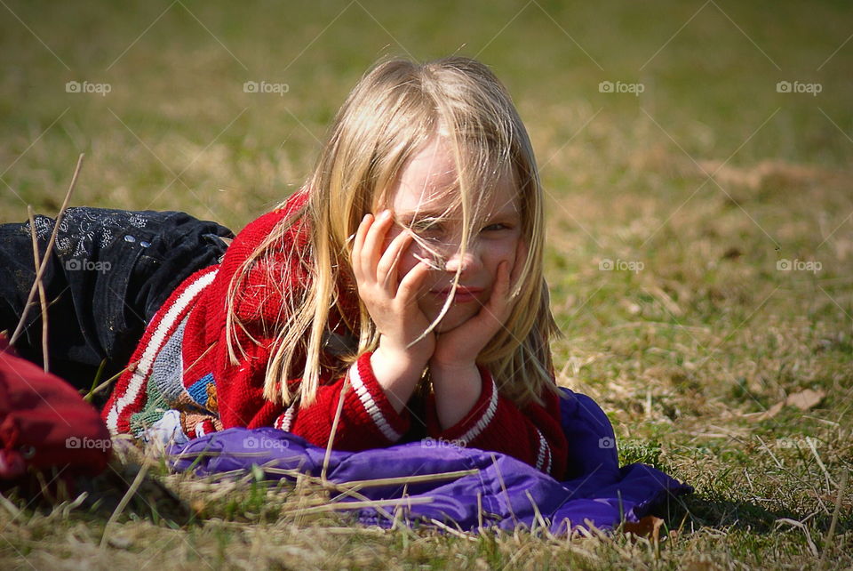 Cute girl laying in the grass