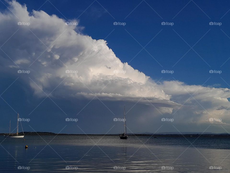 Calm Sea, Boats and Clouds