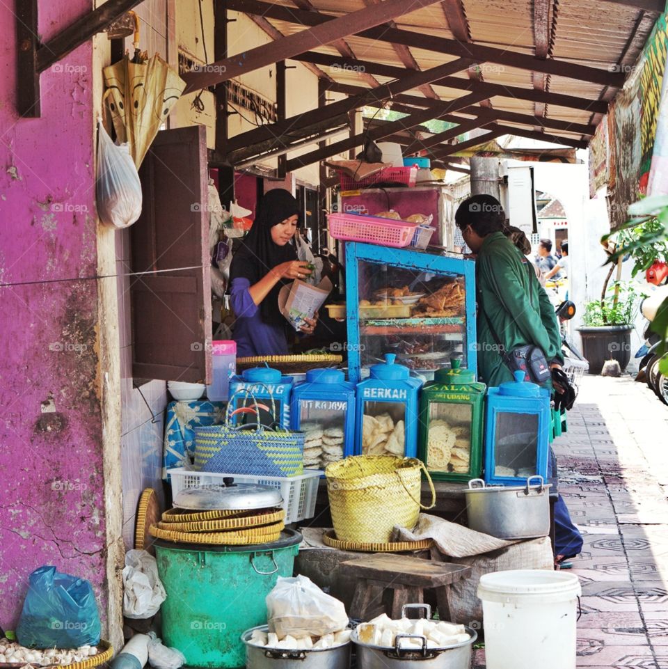Young woman serving food at a shop in Jogjakarta, Java, Indonesia 