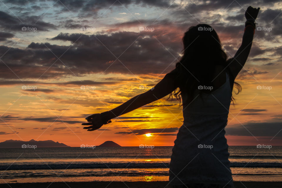 Silhouette of a woman at beach during sunset