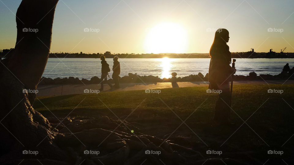 photo story, ladies walking and a woman looking right in silhouettes at sunset