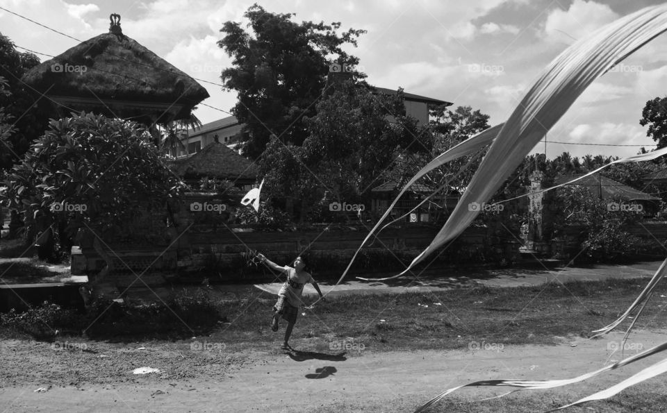 Boy running with a kite