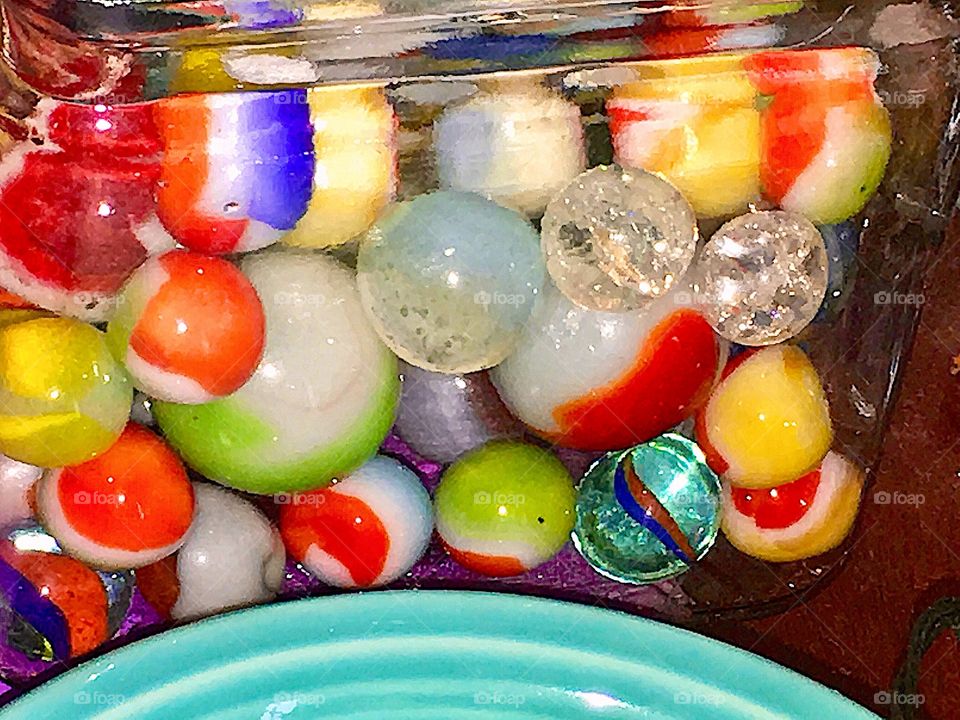 I found my marbles in the chaos around me
Picked spheres catching light, kaleidoscope colors
Contained in glass
Round  aqua bowl  meets rich basic to
Childhood 
