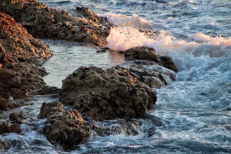 View of the wavy rocky atlantic ocean at sunrise 