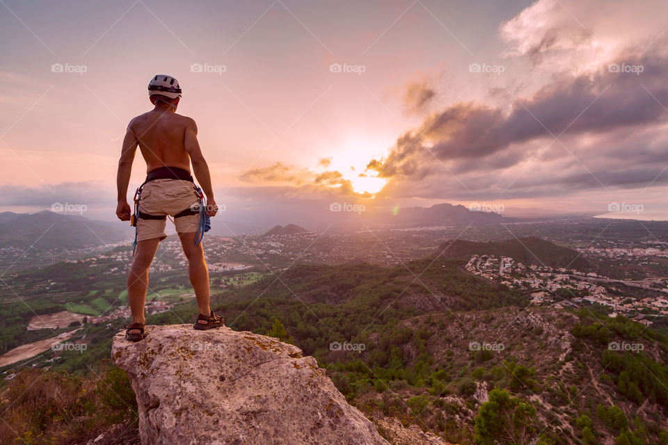 Hiking. Hiker at the top mountain at sunset.