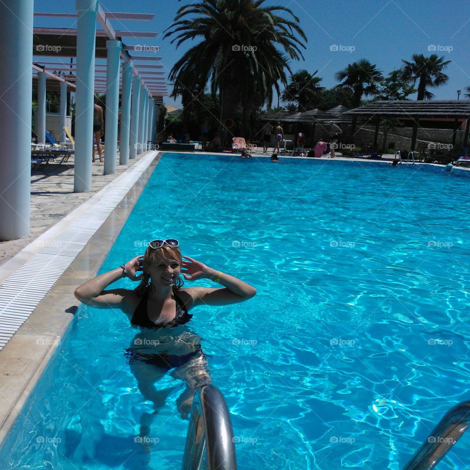 Young woman enjoying in swimming pool