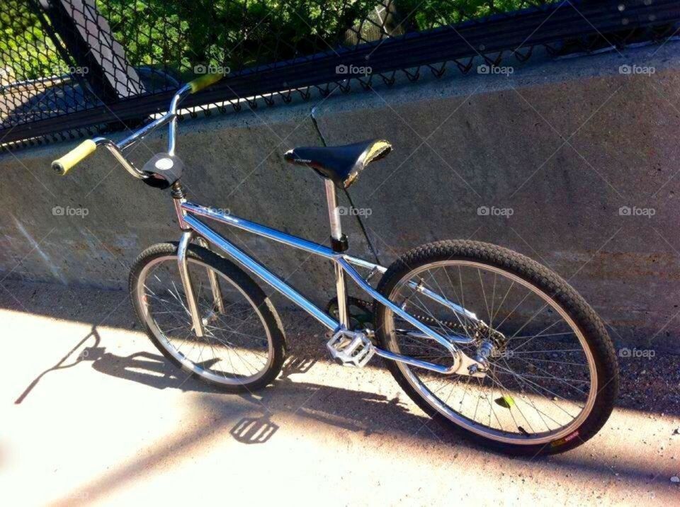 My Mongoose Menace 24" Leaned up against the wall of a bridge crossing above some train tracks