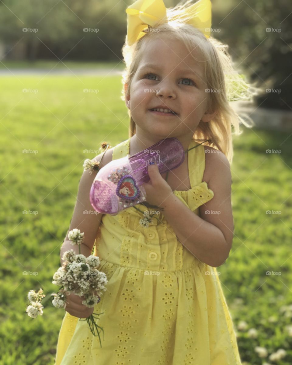 Blond girl with a princess shoe and flowers