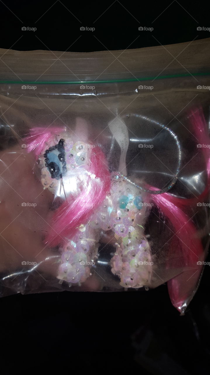 A handcrafted version of My Little Pony, Pinkie Pie. She is light pink with hot pink hair and balloons on her rump. This is a homemade Christmas ornament.