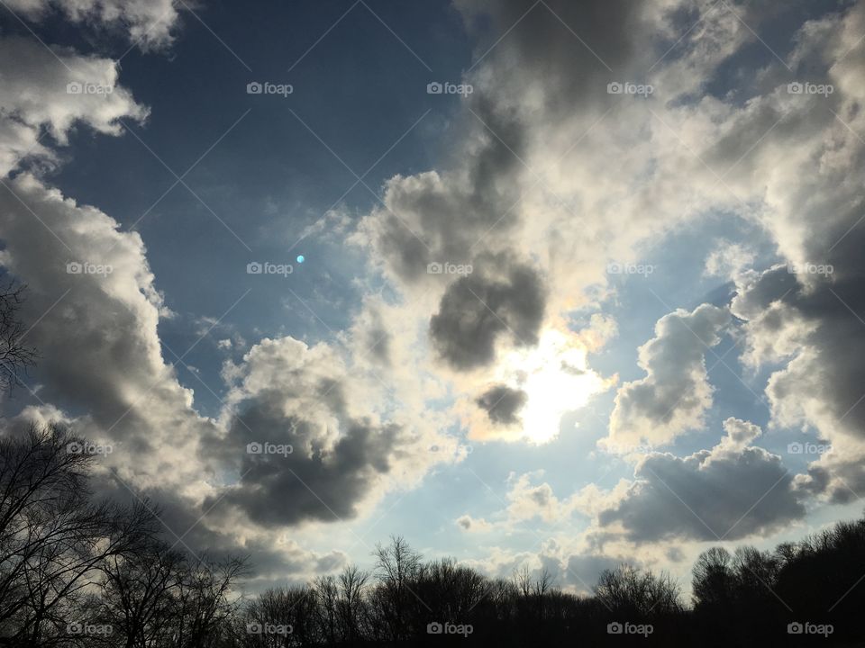 Sun behind the clouds on a cloudy day. 