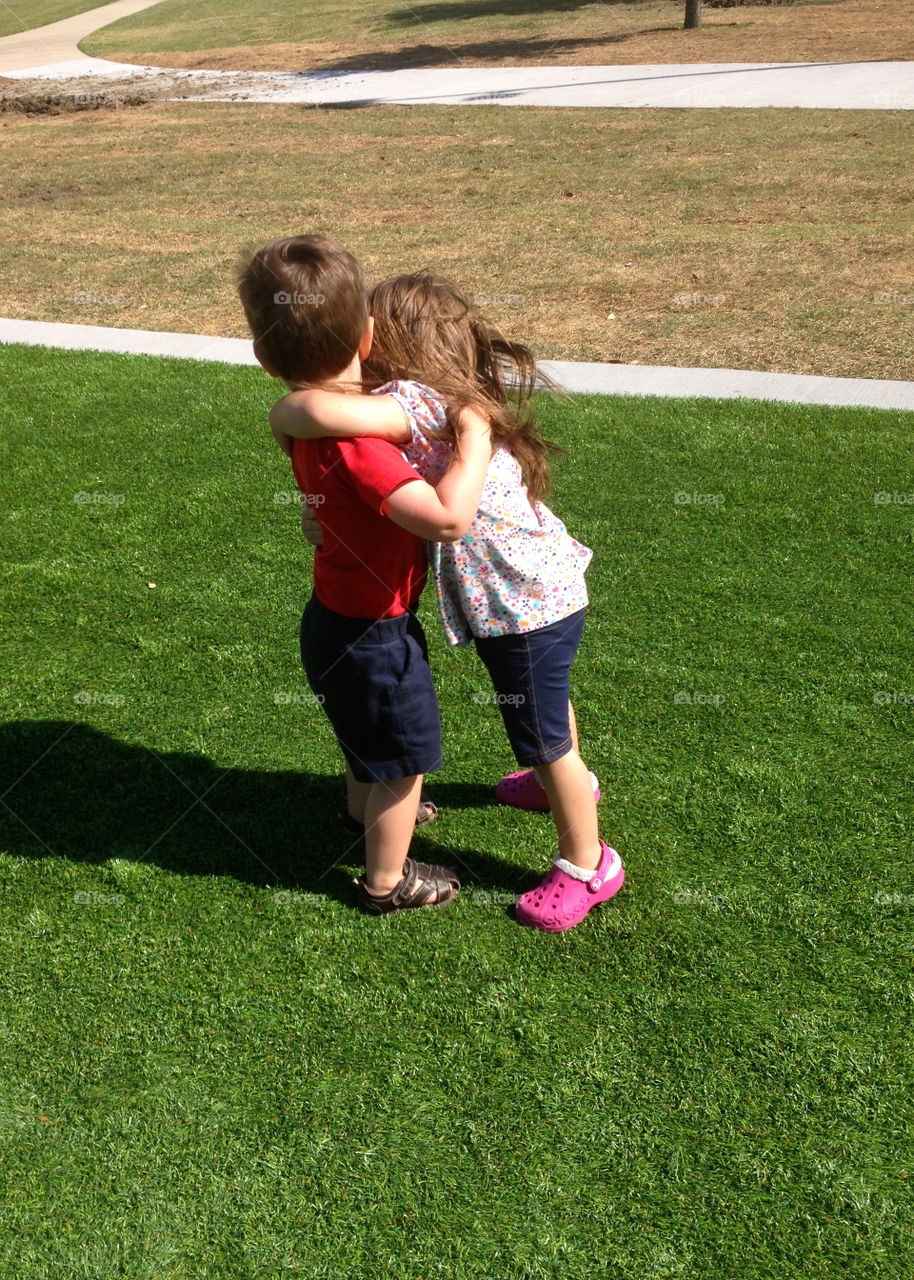 BEST friends giving hugs at the playground