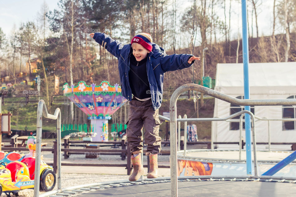 boy is jumping on trampoline in Jurapark Baltow, Poland