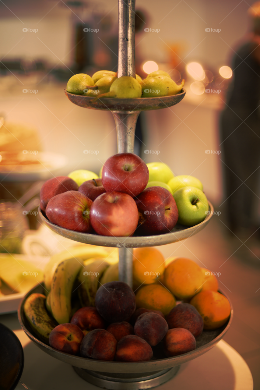 red & green apples on a stand