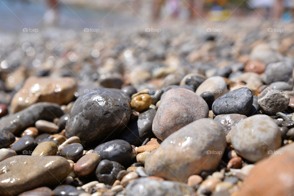 Wet pebbles on beach