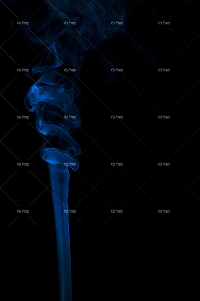Blue abstract smoke swirling on black background