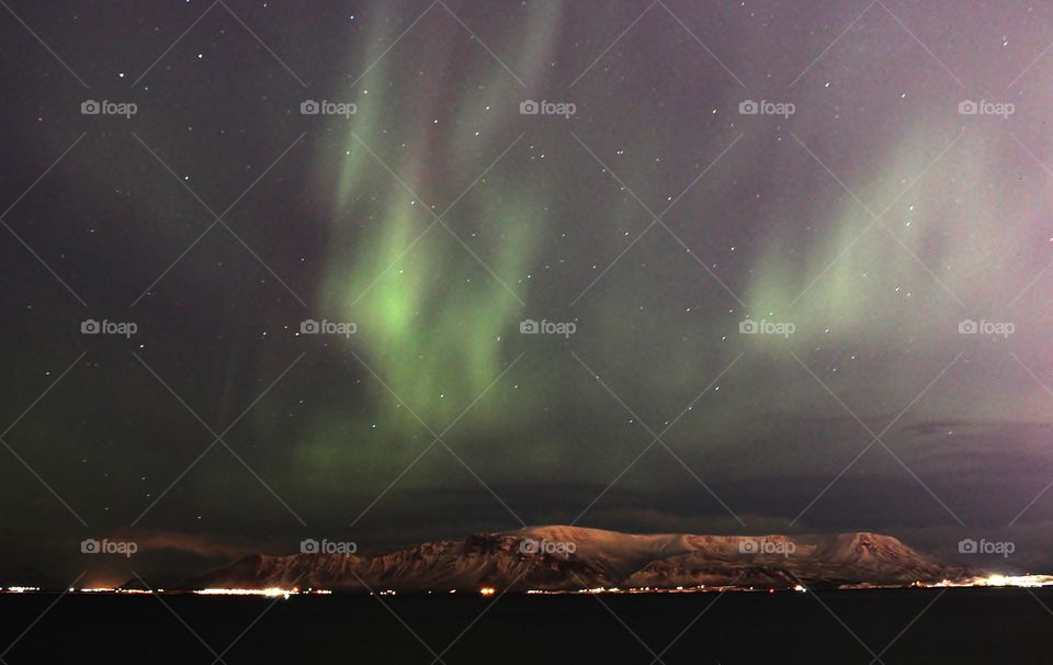 Aurora borealis in Iceland. amazing natural phenomenal. this is taken in the Reykjavik city which has strong light pollution yet the northern light still clearly visible