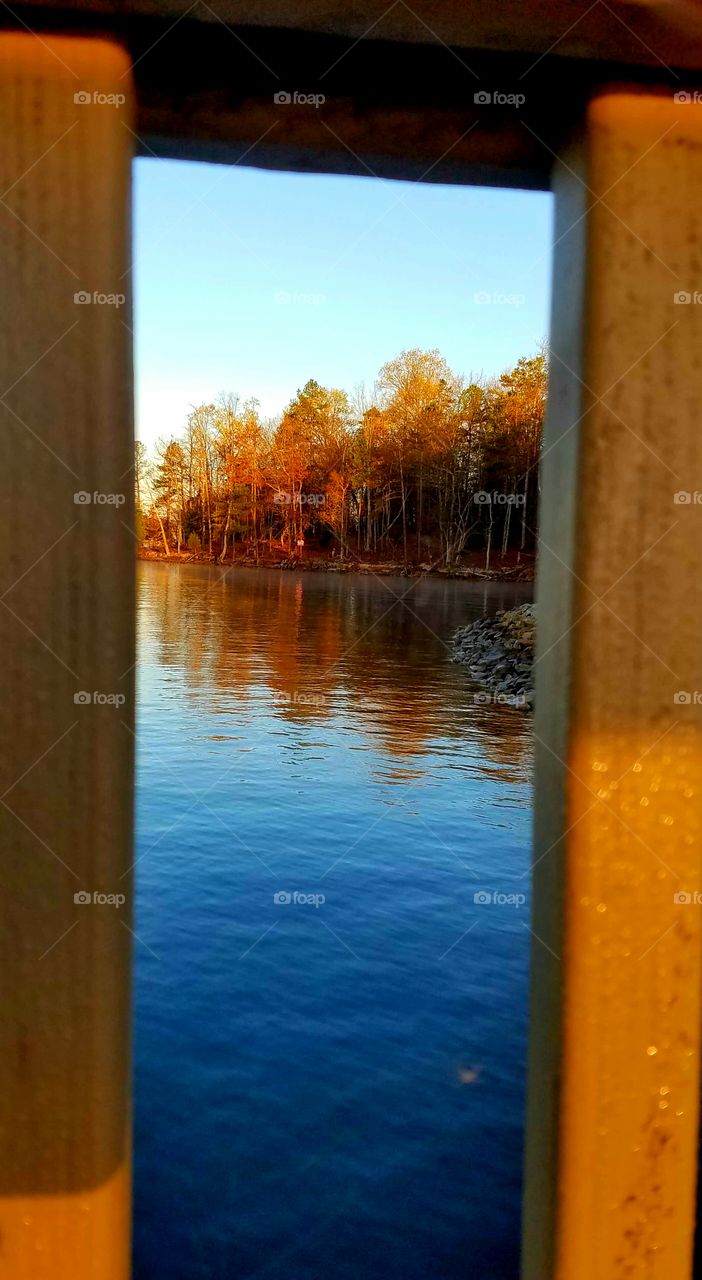 between the railings.  a view of the lake from dock.