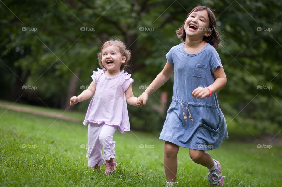 Two girls running in field