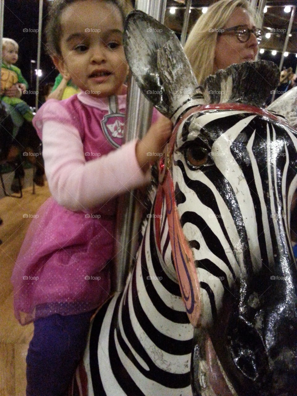 She wanted to ride the zebra!