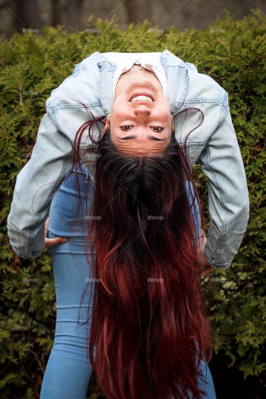 Young woman with a long hair is fooling around