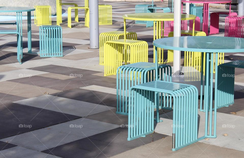 View of the resting place.  Modern design of tables and chairs in soft colors: baby blue,  yellow, and pink