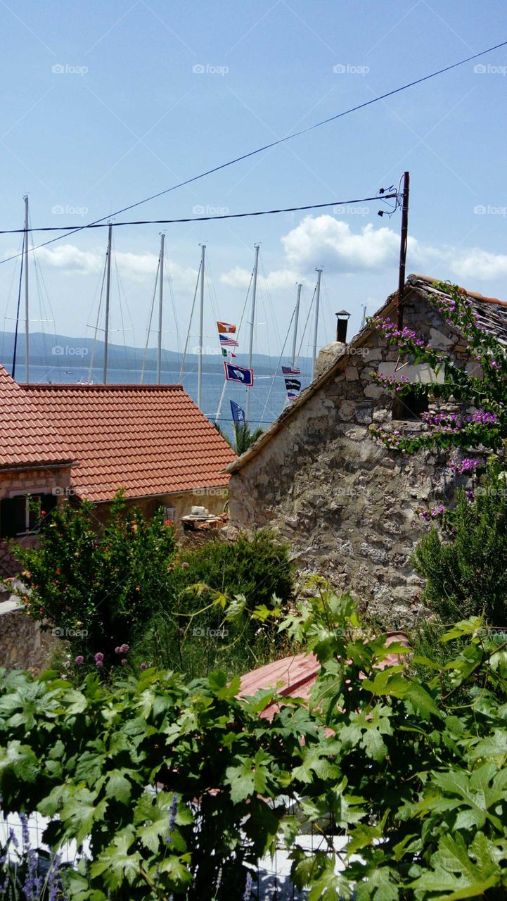 An old stone house and sailing boat