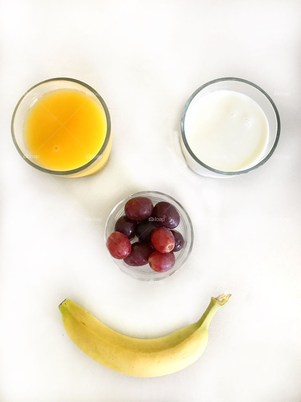 Healthy breakfast with orange juice, milk, grapes and banana 