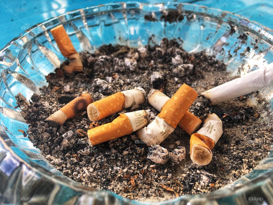 Cigarette butts on ashes