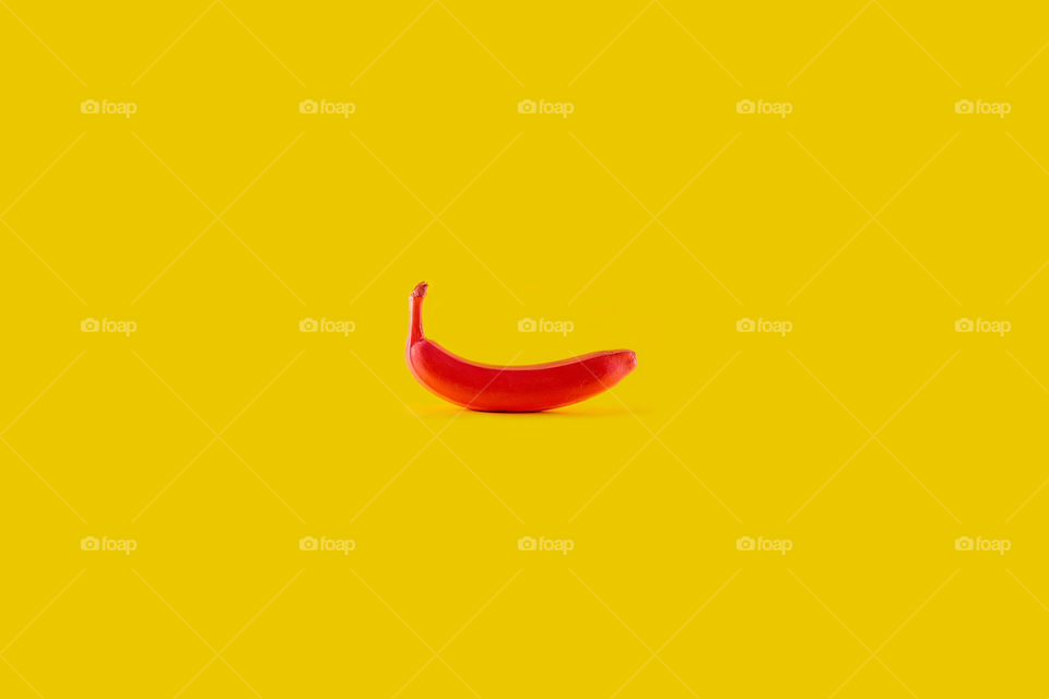 Red banana on yellow background
