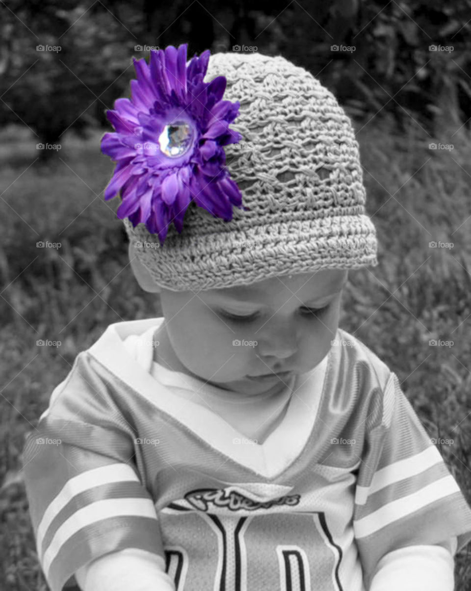 baby girl in flowered hat. Ravens fan in training