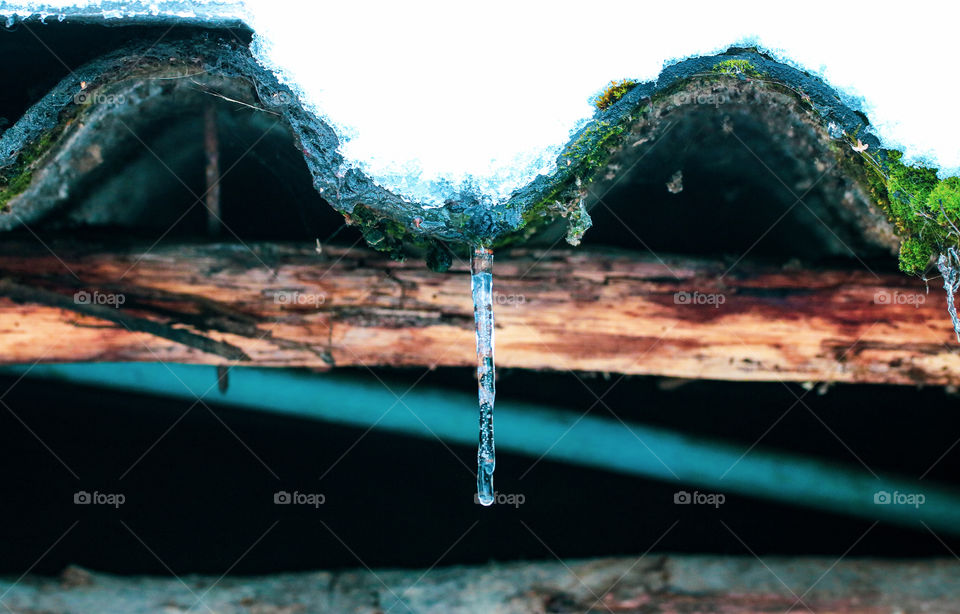 An icecle hanging from the roof