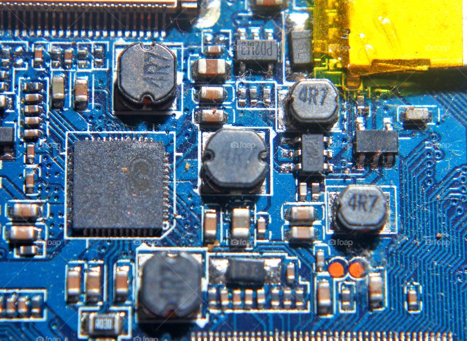 Macro image of electronic circuit on blue electronic board