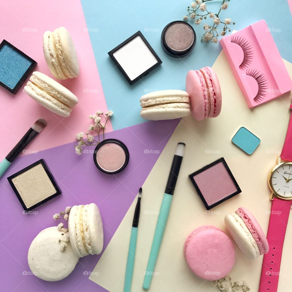 Beautiful flat lay with macaroons and cosmetics