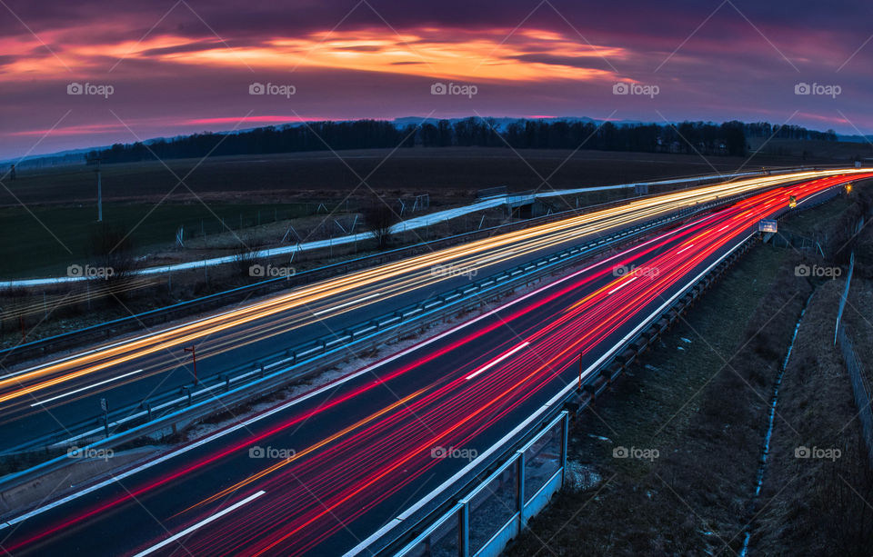 Fast moving traffic light trails at night