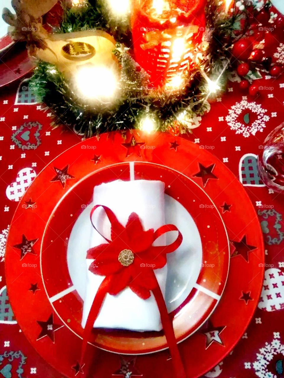 The Christmas theme table: seat marker, red plates, red tablecloth and the candles