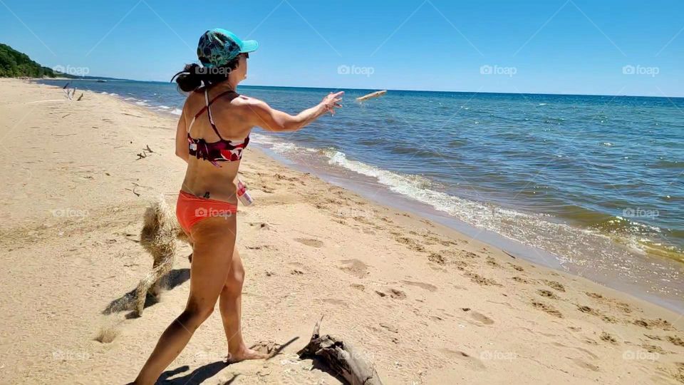 Playing fetch with the dogs on the beach