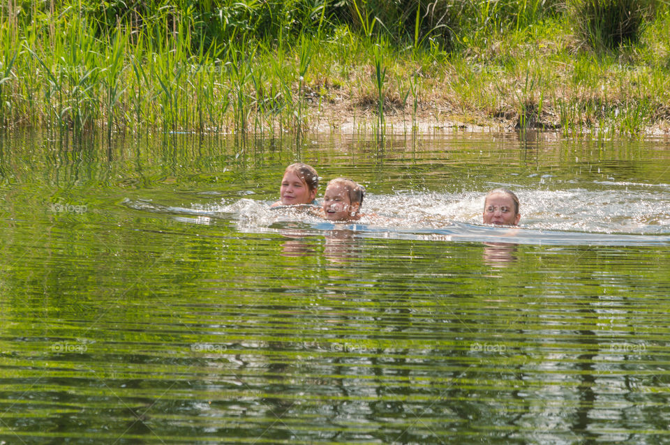 Kids kids are swimming in the lake