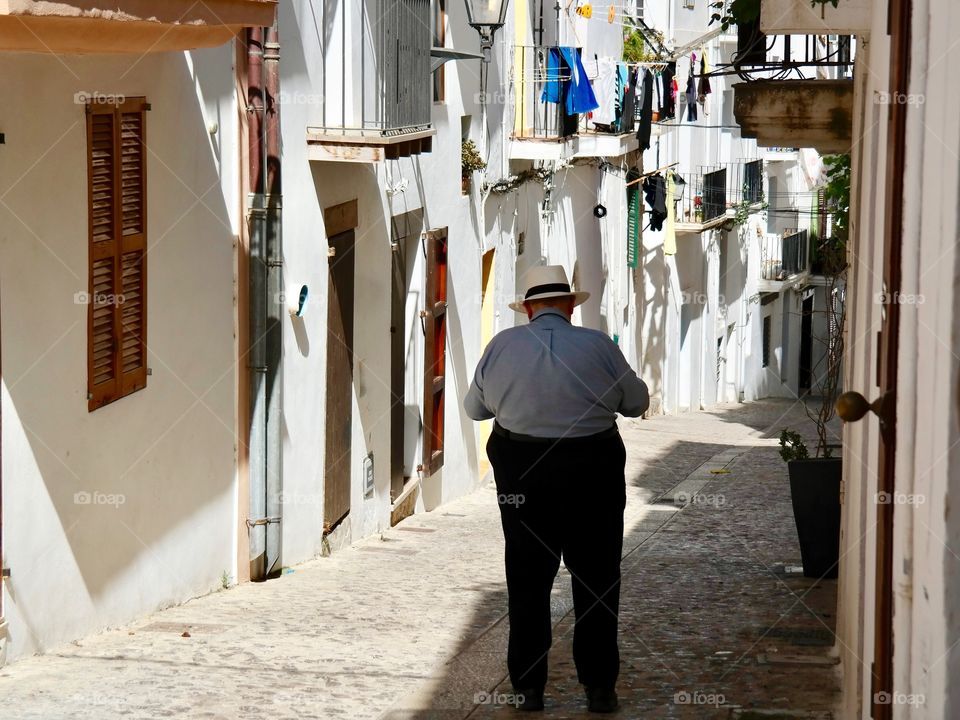 Man walking between buildings 