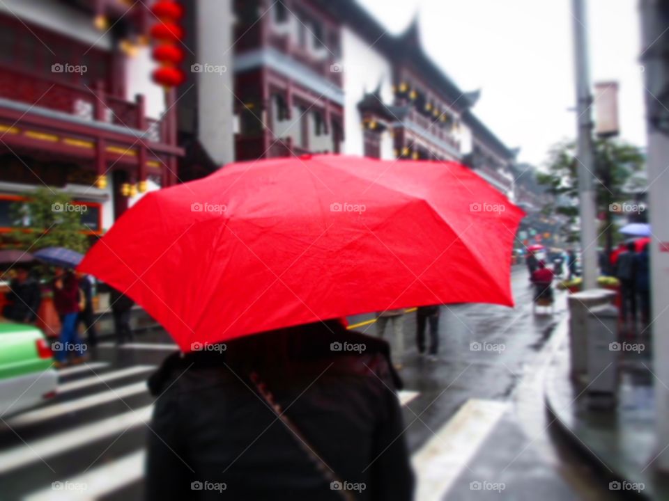 Red umbrella in the rain . Taken on one of our sightseeing trips in Shanghai 