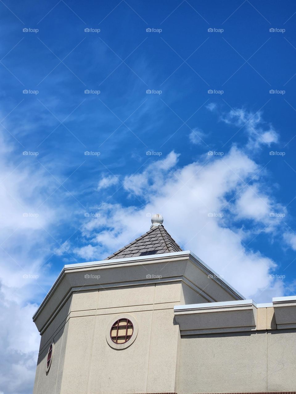 urban building roof top against blue sky in outdoor shopping center