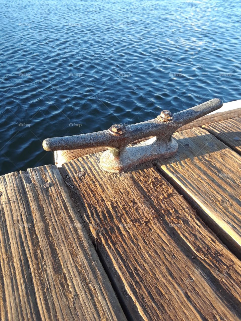 Dock tie wooden planks overlooking water 