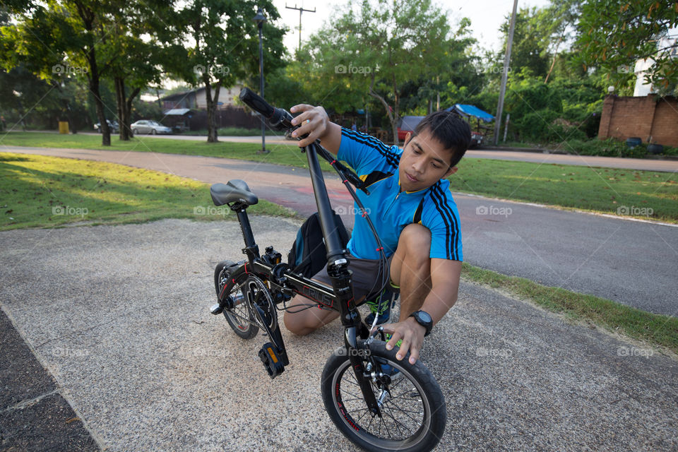 Man fixing bike in the park 