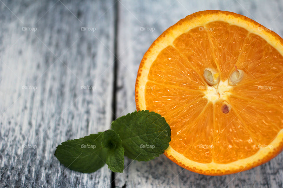 Orange fruit with mint on table