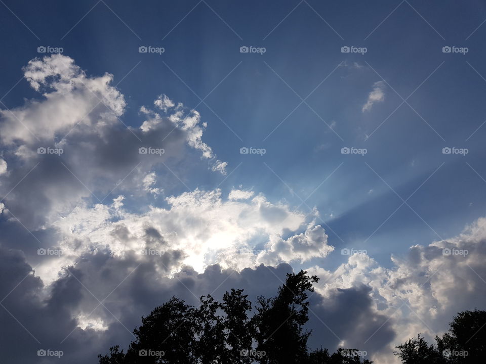 Streaming sun behind clouds