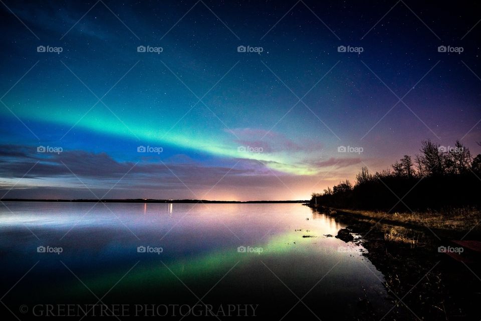 Aurora Borealis reflected on Saskatoon Lake in Grande Prairie Alberta.