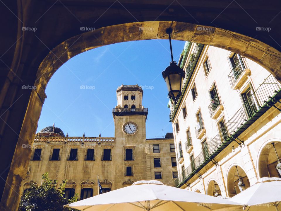 Clock tower seen through an arch