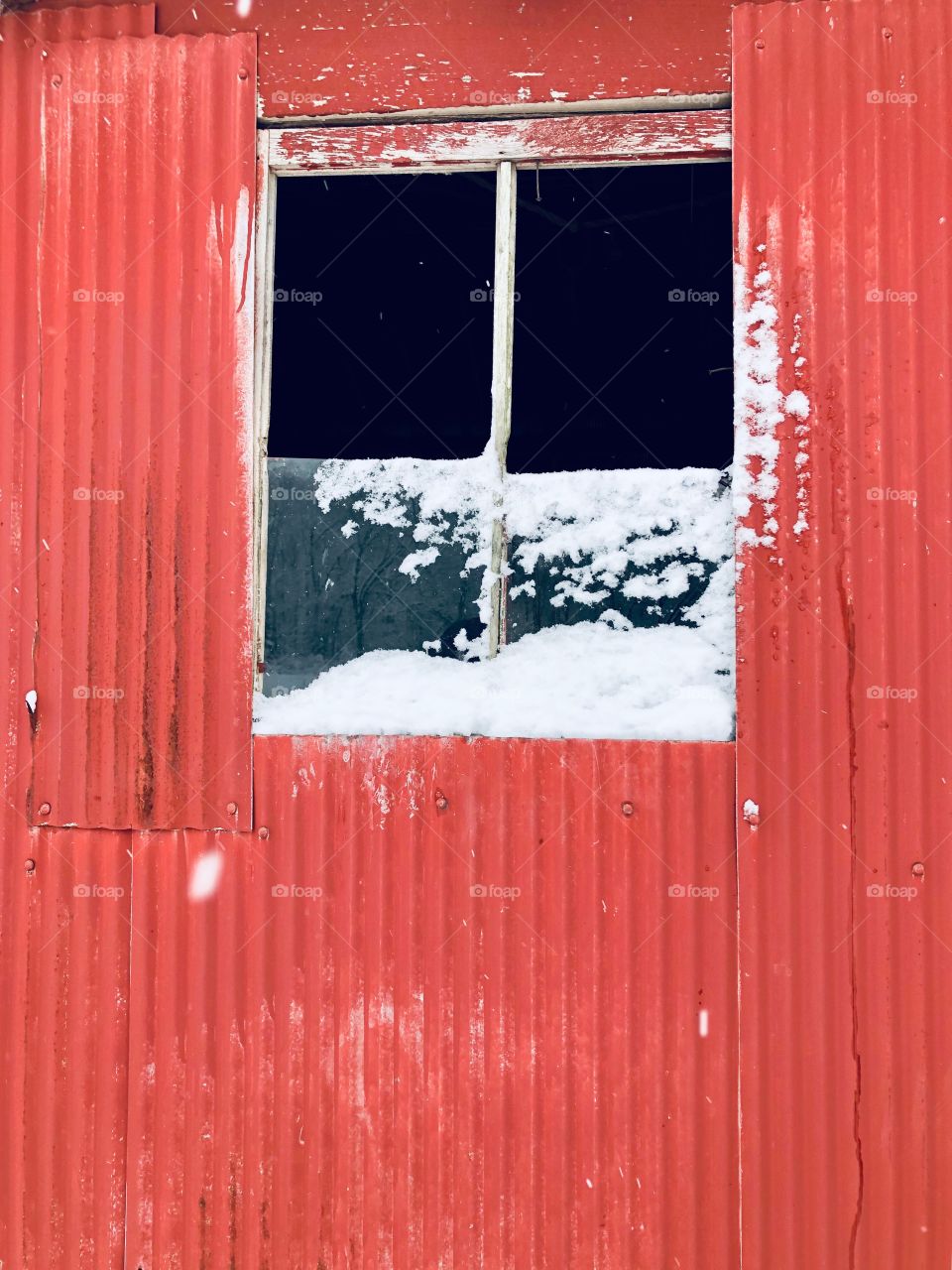 Barn window with snow