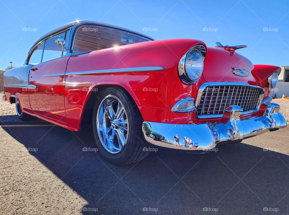 A bespoke 1955 Chevy hot rod sits low and mean and wears plenty of chrome in the Arizona sun