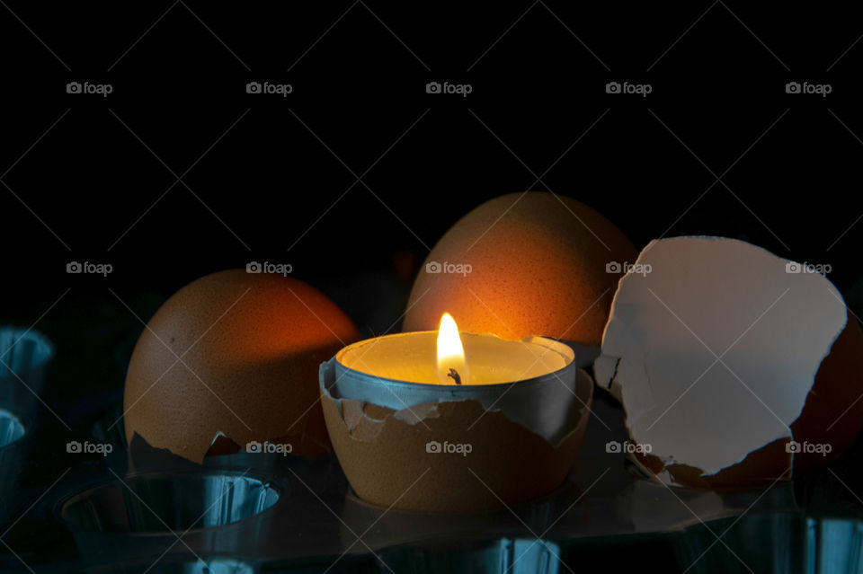 Eggs shells illuminated at night by a candle